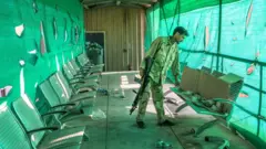 An Afghan army soldier surveys belongings left by the US military inside the Bagram Air Base, some 50 kilometers north of the capital Kabul.