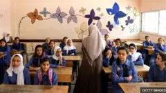 Teacher and students inside a classrooom