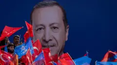 Supporters of Turkey's President Tayyip Erdogan wave flags during a rally ahead of the local elections in Istanbul, Turkey March 30, 2024. REUTERS/Umit Bektas