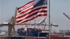 US flag and container ship at Long Beach, California, 1 August 2019