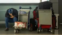 Passengers with luggage at New York's JFK airport. Photo: 26 December 2021