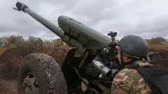 Member of the Ukrainian National Guard prepares a D-30 howitzer for a fire towards Russian troops in Kharkiv region