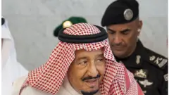 Saudi Arabia's King Salman bin Abdulaziz al-Saud accompanied by his personal bodyguard Gen Abdel Aziz al-Fagham