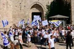 نشطاء من اليمين الإسرائيلي يحملون الأعلام أمام باب العامود في البلدة القديمة بالقدس الشرقية في 5 يونيو/حزيران 2024