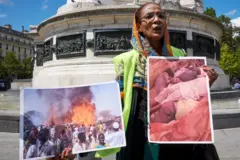 متظاهرة ترفع صوراً لجرائم إنسانية في ولاية غرب دارفور