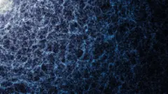 Uma imagem de fundo preto com uma textura de filamentos e pontos azuis e brancos, com algumas áreas mais densas e coloridas do que outras.