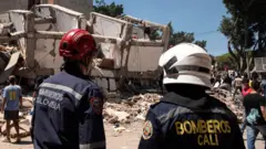 Emergency personnel work at the site of a damaged building after an earthquake, in Cali, Colombia, August 10, 2026.