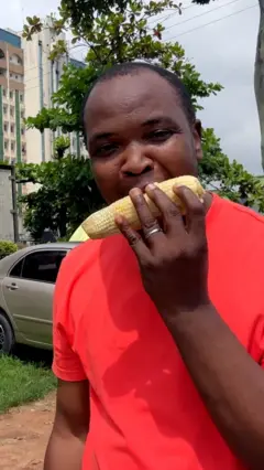 Man eating corn