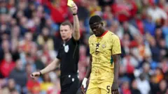 Thomas Partey of Ghana look dejected as chop yellow card from Referee Oscar Johnson during the International Friendly match for 2026
