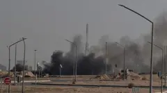 Дым поднимается от места предполагаемого иранского удара в районе, где находится посольство США в Кувейте, 2 марта 2026 года