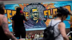 Graffiti on a wall - a depiction of George Floyd with the caption "I can breathe now"