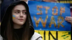A woman looks on as Ukrainian people living in Greece rally against the Russian attack on Ukraine, outside the Parliament at Syntagma square in Athens, Greece, 05 March 2022