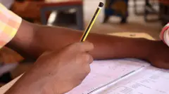 Student holding pencil shading exam paper