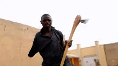 Kabiru with an ax
