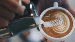 Athenkosi makes latte art