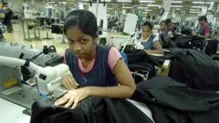 In this photograph dated 15 June 2007, Sri Lankan garment factory worker Dinendra Priyadarshani stitches a pair of denim jeans for a top international label at a factory in Avissawella