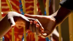 Hand dey hold anoda hand