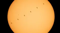 La silueta de la Estación Espacial Internacional contra el Sol