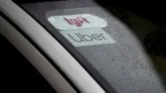 Car with Lyft and Uber stickers