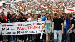 The banner reads: "Not sheep. Not a herd. Not the little people. We are workers of MTZ (Minsk Tractor Plant)"