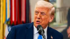 Donald Trump on blue tie, white shirt and black suit