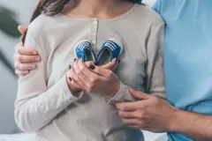 Bebek ayakkabıları tutan bir çift 