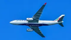 A refurbished Airbus A330-200 of Sri Lanka's debt-ridden national carrier, SriLankan Airlines, is pictured as it flies over Colombo on June 4, 2025, signalling induction as part of re-fleeting efforts