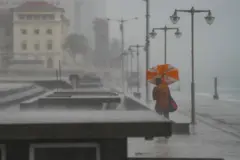 A man holds an umbrella during the heavy rains in Colombo, Sri Lanka, on November 11, 2024. A red warning is issued for severe weather as a low-pressure area intensifies near Sri Lanka