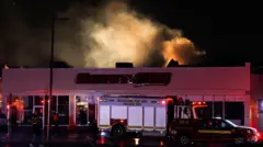 A white cloud of smoke hovers above a building