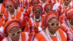 Women wear matching finery for the Egbe Obaneye Obinrin parade in Nigeria