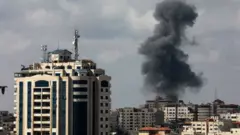 Smoke billows following an Israeli air strike on targets in Gaza City