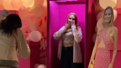 Russians queue up to have photos taken with cardboard cut outs from the Barbie film