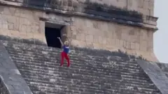Tourist at the top of Mexican pyramid
