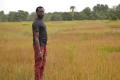 Jean-Louis Mendy  devant des champs désaffectés