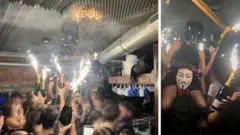Las imágenes verificadas muestran a una empleada, identificada ampliamente como Cyane Panine, sosteniendo bengalas encendidas sujetas a botellas dentro del bar Le Constellation.
