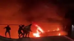 Civil defence forces tackle a fire at a hospital in the southern Iraqi city of Nasiriya