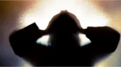 A person holds their head in a treated image