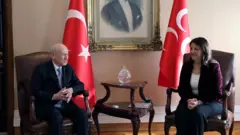 Pervin Buldan ve Devlet Bahçeli bir masanın kenarında karşılıklı otururken 