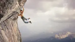 Тоғда қўллари кучи билан осилиб турган эркак