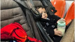 A Palestinian boy, who has a skin infection, looks on at a hospital, amid doctors warning of the spread of diseases and infections among Gazan children due to the ongoing conflict between Israel and Hamas, in Rafah, in the southern Gaza Strip on 12 December 2023