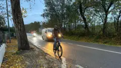 Nuwan is riding his bicycle 