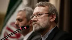 Али Лариджани в черном костюме