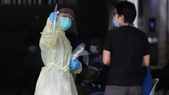 Sağlık çalışanları Singapur'daki yabancı işçilerin kaldığı yurtları kontrol ediyor