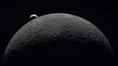 Earth poking out from behind the Moon