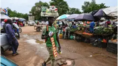A man walks through a market in Niamey