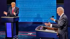 Democratic presidential candidate former Vice-President Joe Biden answers a question as US President Donald Trump