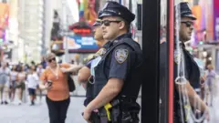 New York City police officers patrol Times Square