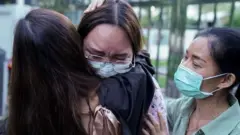 Protest leader Panusaya "Rung" Sithijirawattanakul, who has spent eight weeks in detention on charges of insulting the country"s king, reacts as she leaves after she was granted bail at the Central Women"s Correctional Institute in Bangkok, Thailand, May 6, 2021