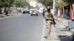 An Afghan security officer stands guard after an explosion in Kabul, Afghanistan, 09 September 2020.