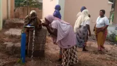 Some of di women dey drink from di borehole dem construct